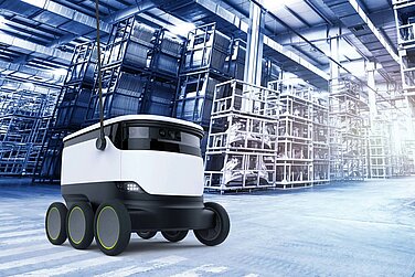 Automated guided vehicle system in front of a high-bay warehouse.