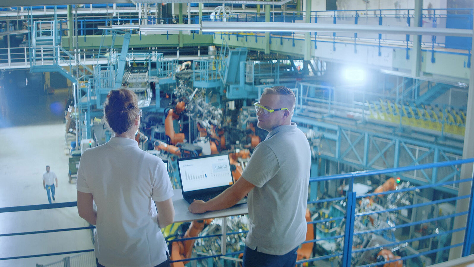 Two Leadec employees checking the performance of an automated production line.