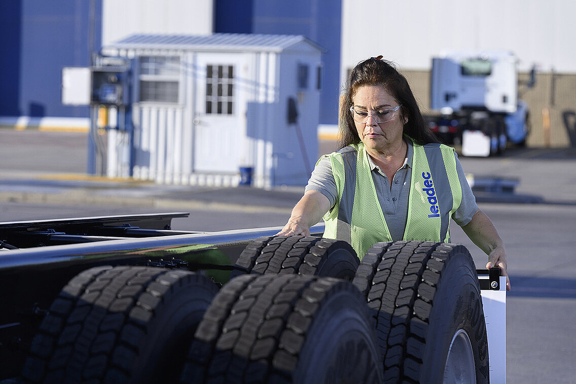 Female Leadec employee checking tyres. 